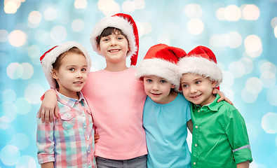 Image showing happy little children in christmas santa hats