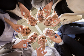 Image showing business people showing ok hand sign at office