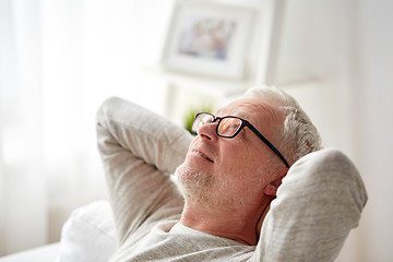 Image showing smiling senior man in glasses relaxing on sofa