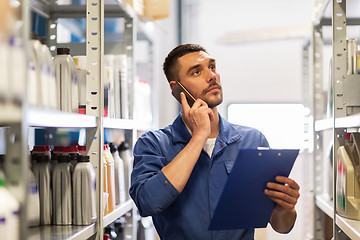 Image showing auto mechanic with clipboard at car workshop