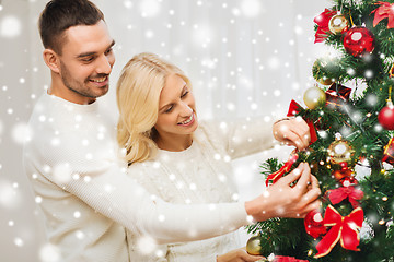 Image showing happy couple decorating christmas tree at home