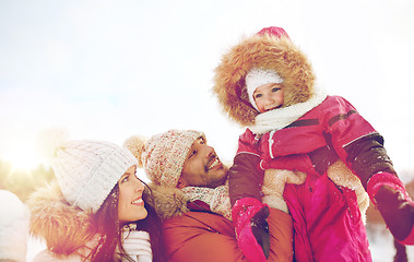 Image showing happy family with child in winter clothes outdoors