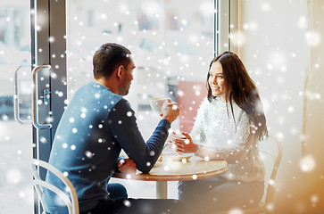 Image showing happy couple drinking tea and coffee at cafe