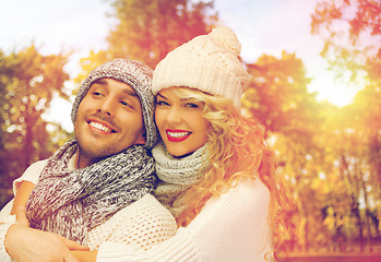 Image showing happy couple in warm clothes over autumn