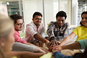 Image showing group of international students with hands on top