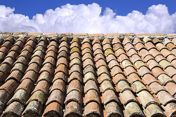 Image showing Old roof tiles, blue sky and clouds in the background