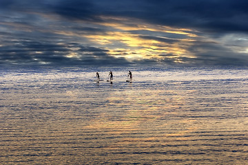 Image showing Young people Paddling Together in the sea