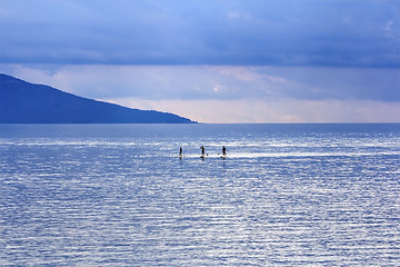 Image showing Young people Paddling Together in the sea