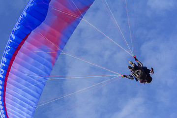 Image showing Tandem Paragliding on background of blue summer sky and white cl