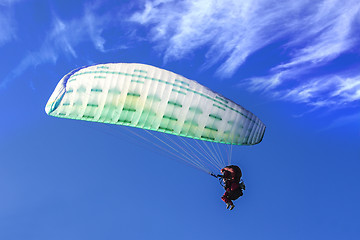 Image showing Tandem Paragliding on background of blue summer sky and white cl