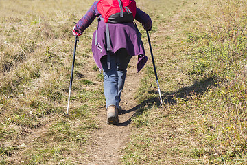Image showing Older woman walking by hiking trail