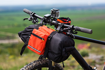 Image showing Bicycle with orange bags for travel