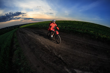 Image showing Young man is riding bicycle outside. Healthy Lifestyle.