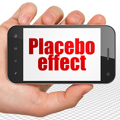 Image showing Health concept: Hand Holding Smartphone with Placebo Effect on display