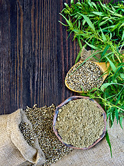 Image showing Flour hemp in bowl and seed in spoon on board