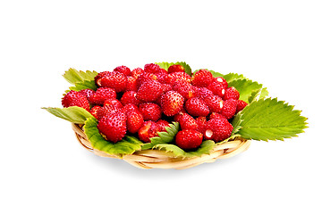 Image showing Strawberries with leaves on wicker tray