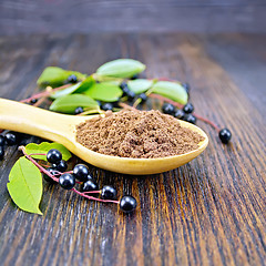 Image showing Flour bird cherry in spoon on dark board