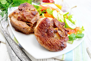 Image showing Turkey steak roasted with vegetables on light board