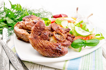 Image showing Turkey steak roasted with vegetables and basil on board