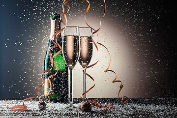 Image showing Open bottle of champagne and two filled glasses, festive composition