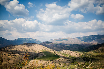 Image showing Panoramic scenic views of hilly valley and blue cloudy sky
