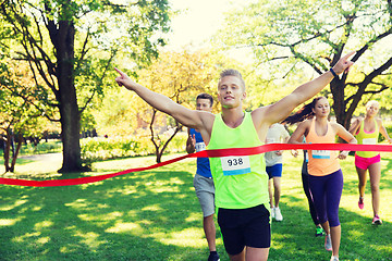 Image showing happy young male runner winning on race finish