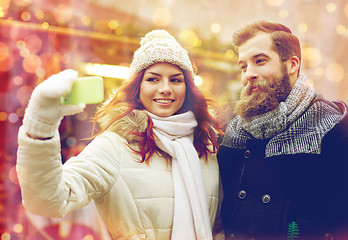 Image showing couple taking selfie with smartphone in old town