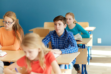 Image showing group of students with notebooks at school lesson