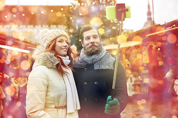 Image showing couple taking selfie with smartphone in old town