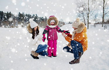 Image showing happy family with child in winter clothes outdoors