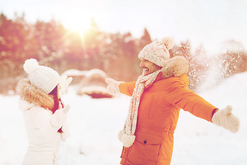 Image showing happy couple playing with snow in winter