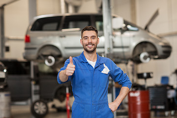 Image showing happy auto mechanic man or smith at car workshop