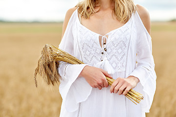 Image showing close up of happy woman with cereal spikelets