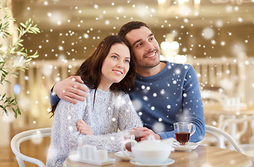 Image showing happy couple drinking tea at restaurant