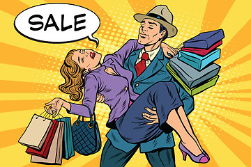 Image showing Discounts and sales. Retro man carrying woman on his hands