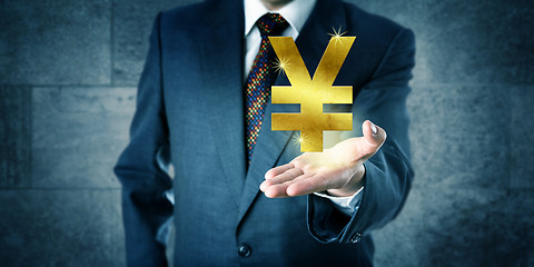 Image showing Financial Trader Offering A Golden Yuan Or Yen