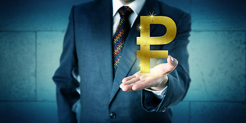 Image showing Banker Offering A Golden Russian Ruble Symbol