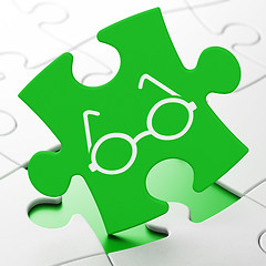 Image showing Learning concept: Glasses on puzzle background