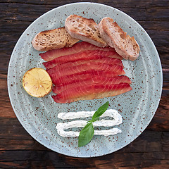 Image showing Green plate with sliced salmon