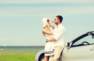 Image showing happy man and woman hugging near car at sea