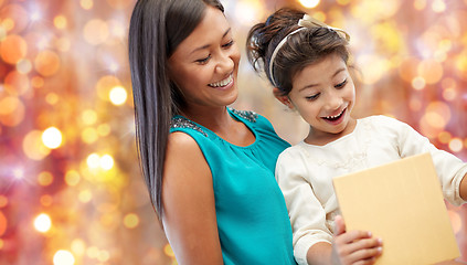 Image showing happy mother and girl with gift box over lights