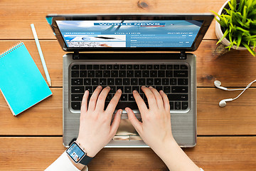 Image showing close up of woman with world news on laptop