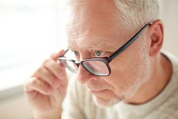 Image showing close up of senior man in glasses looking