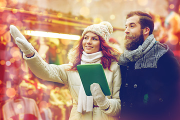 Image showing happy couple walking with tablet pc in old town