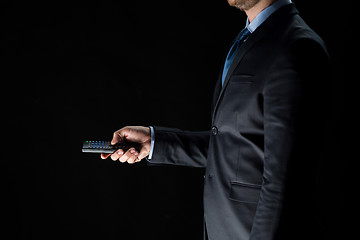 Image showing close up of businessman with remote controller