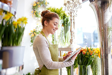 Image showing woman with tablet pc computer at flower shop