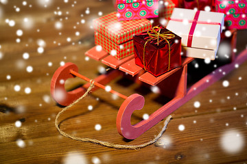 Image showing close up of christmas gift boxes on wooden sleigh