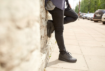 Image showing close up of man standing at street wall