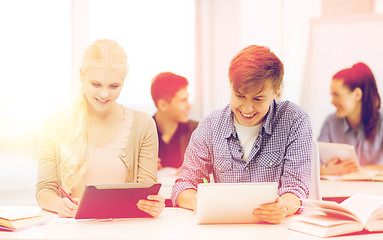 Image showing two smiling students with tablet pc at school