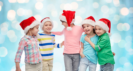 Image showing happy little children in christmas santa hats